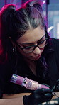 Artist, woman and tattoo on leg in shop, aesthetic and creative ink design with equipment or skills. Needle, sketch and person with tool for self expression, outline and client with body art in store