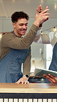 Men, barista and tablet with high five for success, social media and food truck cafe teamwork. People, tech and waiter for customer service, partnership or mobile coffee shop review for celebration