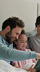 Bedroom, tablet and parents with kid for bonding together, play game and online entertainment at home. Tech, mother and father with girl on bed for puzzle app, browsing and relax with happy family