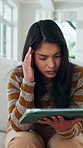 Woman, headache and disappointed in home with tablet, reading rejection letter or unemployment crisis. Person, stress and migraine in living room with tech, job search struggle and financial problem.