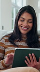Woman, smile and scroll in living room with tablet, social media post and search website for ebook. Happy person, relax and browsing in home with tech, check internet or digital app for online story.