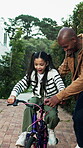 Father, child and bicycle in driveway with help, training lesson and applause for learning success. Happy man, daughter and clap outdoor by home with bike, care and celebration for skill development.