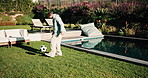 Soccer, ball and kid in backyard by home for practice, exercise or sports game development. Kicking, energy and boy child outdoor for football training, workout or match with skill by house garden.