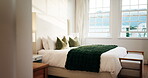 Luxury, room and bed in hotel, interior design and furniture with decor, real estate and hospitality. Empty, accommodation and cozy blanket in bedroom, comfort and tidy motel or travel destination