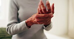 Home, hands and senior woman with joint pain for arthritis inflammation, chronic illness or massage. Retirement, elderly person and finger stiffness on bed with discomfort, rheumatism risk and sore