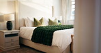 Luxury, room and bed in hotel, hospitality and furniture with decor, real estate and interior design. Empty, accommodation and cozy blanket in bedroom, comfort and tidy motel or travel destination
