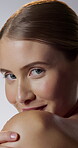 Beauty, face and shoulder with happy woman in studio for cosmetics, dermatology or hydration. Aesthetic, shy and smile with person on white background for facial grooming, skincare or wellness