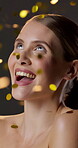 Beauty, face and glitter with happy woman in studio for cosmetics, celebration or dermatology. Aesthetic, confetti and smile with person on gray background for skincare, surprise or wellness