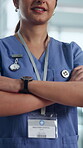 Happy, nurse and arms crossed in hospital, healthcare and confident for medical service and medicine. Clinic, health professional and person with smile, wellness and pride for career development