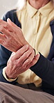 Hands, wrist pain and old person in home with massage, arthritis complication or poor blood circulation. Retirement, elderly resident or sore in tendons with joint ache, osteoporosis or carpal tunnel