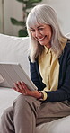 Laughing, home and senior woman with tablet, entertainment and searching ebook with app subscription. Happy, mature person and relax with technology, online and reading novel on website in house