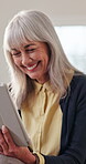 Senior woman, home and relax with tablet, entertainment or reading funny ebook with app subscription. Laughing, mature person and happy with technology, online and review novel on website in house