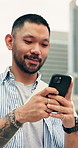 Phone, walking and man in city with texting, chatting or email for feedback on creative  project. Happy, commuting and Asian person with cellphone for research on web development for update in town.