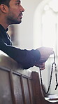 Funeral, worship and rosary with man in church for memorial service, christian religion or grief. Eulogy tribute, catholic congregation and prayer beads with person in cathedral for belief and chapel