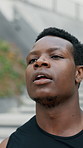 Breathe, fitness and black man in city for running exercise, outdoor workout or training for cardio health. Tired runner, thinking or sports person with fatigue, rest and relax on break in New York