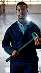 Construction, face or black man on site with sledgehammer, contractor or confidence in demolition. Flare, smoke or engineer on worksite with tool, wrecking worker or about us in industrial industry.