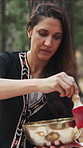 Meditation, calm or woman outdoor with tibetan bowl, spiritual practice or healing in holistic health. Zen, frequency or healer with instrument, sound therapy or grounding vibration in nature session