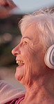 Headphones, dancing and senior woman by beach on holiday with music, playlist or radio outdoor. Happy, audio tech and elderly person in retirement listening to album at ocean disco on vacation.