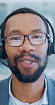 Telemarketing, face and man with headset in office, explaining service or communication with contact. Call center, consultant and black person with glasses, happy and virtual assistance with mic