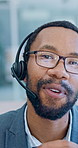 Telemarketing, face and man with headset in call center, consultation or communication with contact. Agent, talking and black person with glasses, service and discussion with mic and explaining offer