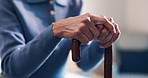 Senior, woman and hands with cane in retirement home for balance, mobility or medical aid. Elderly, female person or walking stick with comfort for pension, assisted living or healthcare in house