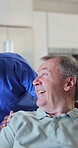 Happy, old man and discussion with nurse in nursing home, laughing and connection healthcare worker. Caregiver, smile and bonding with senior person, homecare and comfort for patient and elderly care