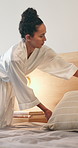 Tidy, morning and woman with pillow on bed for cleaning, maintenance and daily routine in home. Bedroom, housekeeping and person with bedding, blanket and comfort for neat, organizing and chores