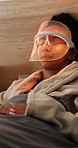 Health, mask and woman with red light therapy on bed in home for skincare, relax or wellness. Beauty, calm and person with infrared LED treatment for dermatology with collagen production in house.