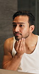 Mirror, bathroom and man check face for beard care, grooming and wellness for morning routine. Home, reflection and person with inspection, growth and texture for health, maintenance and facial hair