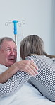 Old couple, hug and support in hospital room, talking or compassion for elderly partner with illness. Healthcare, recovery and senior people with affection, embrace and discussion with sick spouse