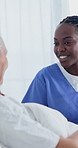 Woman, nurse and discussion with senior patient in hospital bed for medical checkup or assistance. Female person, caregiver or doctor with smile for elderly care, diagnosis or treatment in clinic