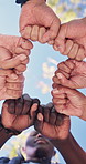 Hands, people and fist bump in nature for volunteering, support and solidarity for community service. Low angle, team or circle at park with trust, ngo collaboration and synergy for charity agreement