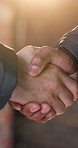 Construction, handshake and people in building for meeting, agreement and renovation approval. Contractor, architect and men shaking hands for partnership, deal or remodeling for property development