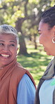 Happy, women and volunteers walking in nature with bonding, solidarity or connection for NGO. Smile, talking and  charity workers with pride for non profit organization with about us in park.