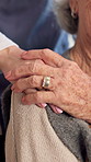 Elderly, woman and hands with caregiver on wheelchair for assisted living or healthcare in home. Senior, nurse or female person with a disability for comfort, support or mobility in retirement house