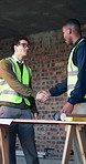 Engineer, team and meeting on construction site with handshake, property development or discussion. Architecture, men and shaking hands in building with manager, planning or advice for infrastructure