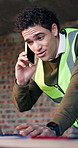 Man, laptop and phone call on construction site for blueprint, inspection or update planning. Infrastructure, quality control and engineer with tech, discussion or project management for remodeling