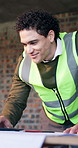 Construction, man and smile with laptop on site for blueprint correction, design and renovation. Project manager, tech and happy with CAD for building compliance, layout change and safety regulations
