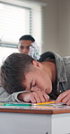 Students, throwing and sleeping boy in classroom, playful prank and disruption for sleep deprivation. Tired, child and nap on desk with peer interaction, paper ball and exhausted for boring lesson