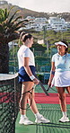 Smile, people and talking on court for tennis, fitness and exercise discussion for match practice. Happy, friends or laughing on turf with racket, funny conversation and game strategy for competition