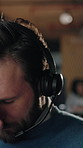 Call center, headache and man in agency with headset, frustrated or tired in customer service. Burnout, overwhelmed or person with mic, migraine pressure or workload fatigue in crm management.