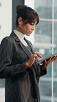 Businesswoman, reading and typing by window with tablet, email and paralegal for court case admin. Mature person, law clerk and research legislation in office with tech, planning and lawsuit review.