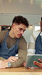 Men, barista and tablet with discussion for menu, social media and food truck cafe teamwork. People, tech and waiter for customer service, partnership or mobile coffee shop review with planning