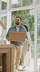 Couple, box and moving in new home for relocation, investment or fresh start together. Happy, man and woman walking with package, suitcase or parcel by entrance door for property in aparment or house
