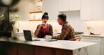 Laptop, couple and discussion for budget in kitchen, review expenses and mortgage paperwork. Computer, mature man and woman with bills, insurance application or pointing for planning savings at home