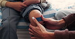 Injury, child or hands of mother with plaster on bed for first aid, healing or wound care for knee. Apply, kid or parent with leg bandage in home for bruise protection, accident support or assistance