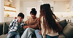Parents, children and sofa with hug in home for comfort, bonding or weekend together. Mom, dad or kids relaxing with smile or embrace on living room couch for family time, holiday or break in house