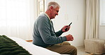 Senior, man and smile in retirement home with phone, reading news and notification for text message. Happy, elderly person and browsing in bedroom with tech, social media post and digital article.