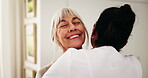 Happy, hug and caregiver with senior woman in home for support, comfort or good news on treatment. Smile, healthcare and medical worker embracing elderly patient for trust at consultation in house.