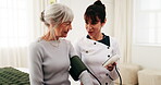 Caregiver, test and old woman in retirement home for blood pressure machine, medical advice or help. Senior person, healthcare worker and talk in bedroom with equipment, hypertension exam or support.